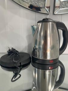a tea kettle sitting on top of a mixer at Awangan Palace in Kuantan