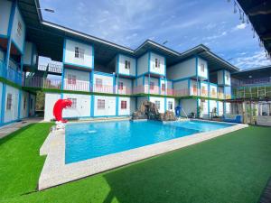 a hotel with a pool in front of a building at Awangan Palace in Kuantan
