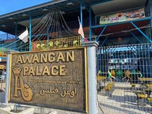 a sign for an american palace in front of a building at Awangan Palace in Kuantan