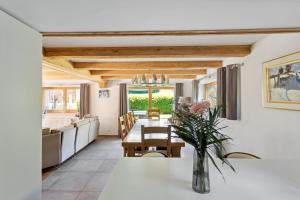 a dining room and living room with a table at Chalet Haute Cime by Mrs Miggins in Champéry