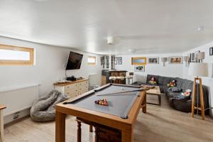 a living room with a ping pong table at Chalet Haute Cime by Mrs Miggins in Champéry