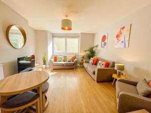 a living room with a couch and a table at Charming Old Town 2 Bed Apt, 2mins from Royal Mile in Edinburgh +21 photos