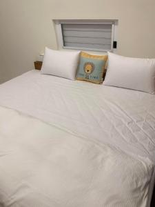 białe łóżko z poduszką na górze w obiekcie Star & Moon GUEST HOUSE w mieście Puli