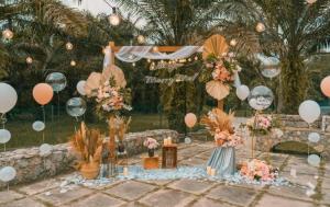 a table with pink and white flowers and balloons at Holistay Forest Villa I 34 Pax I Gathering I Team Building I Wedding in Hulu Yam Baharu