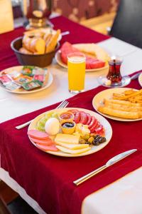 een tafel met borden eten op een rode tafeldoek bij Pamuk City Hotel in Gaziantep