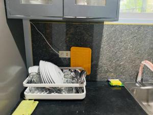 a kitchen counter with a dish drying rack with dishes at B1 - Spacious 3BR House with Netflix, Fiber Wifi, Parking, Balcony in Cagayan de Oro +48 photos