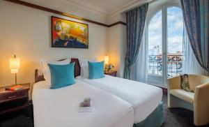 a hotel room with a large bed and a window at Hôtel Pont Royal Paris in Paris +69 photos