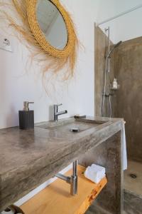 a bathroom with a concrete sink and a mirror at Monte do Pocinho in São Domingos