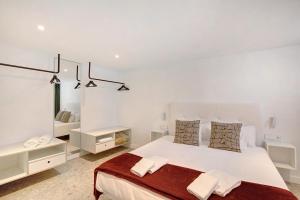 1 dormitorio blanco con 1 cama grande y armarios blancos en Linaje del Pago Negramol, en Sauzal 21 fotos más