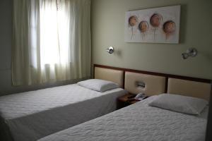 Кровать или кровати в номере Ecos Hotel Tourist