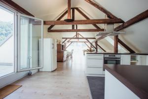 a kitchen with white appliances and a large window at Hotel Trabener Hof in Traben-Trarbach