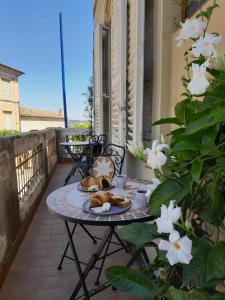 a table with a plate of food on a balcony at Ballerina Bianca bed & breakfast in Grottazzolina