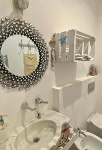 a bathroom with a sink and a mirror at Le Stanze sul Mare in Portoferraio +75 photos