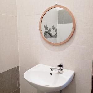 a bathroom with a white sink and a mirror at One Room in Vung Tau