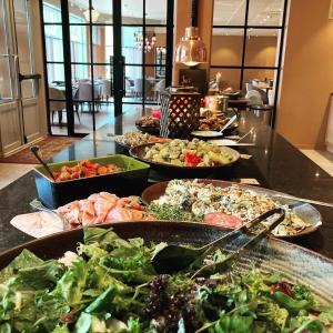 a table with many plates of food on it at Clarion Collection Hotel Hammer in Lillehammer