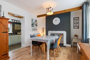a kitchen and dining room with a table and chairs at Ocean Cottage - Walk to Beach Countryside Views in Saundersfoot +22 photos