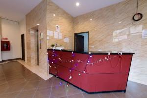 a lobby with a red dresser with christmas lights at The Hideaway Resort Pattaya in Pattaya South