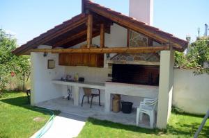 a outdoor kitchen with a counter in a backyard at Studios Ioulia in Keramoti