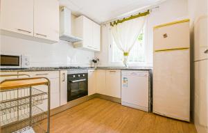 a kitchen with white cabinets and a refrigerator at Stunning Home In Arcos De La Frontera in Arcos de la Frontera