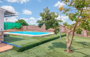 a swimming pool in a yard with a tree at Stunning Home In Arcos De La Frontera in Arcos de la Frontera +15 photos