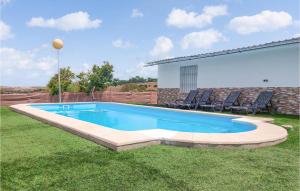 a swimming pool in a yard with chairs around it at Stunning Home In Arcos De La Frontera in Arcos de la Frontera