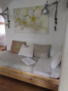 a couch in a room with flowers on the wall at El Atico de Villalmar in Tui
