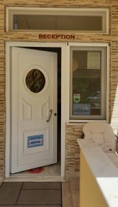 a white door with a registration sign on it at Studios Ioulia in Keramot&iacute;
