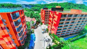 una vista aerea di due edifici alti in una città di Naiharn Pearl Condo Hotel by VillaCarte a Nai Harn Beach