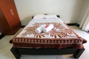 Sanata Homestay房間的床