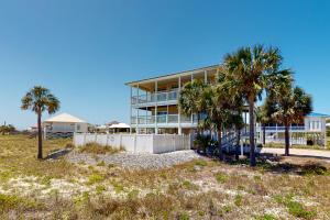 a building with palm trees in front of it at Dream Chaser in St. George Island