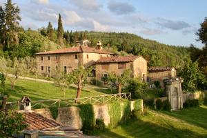 an old house in the middle of a field at Villa Farmhouse with swimming pool in Chianti in Grassina