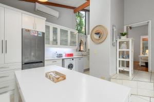 a kitchen with white cabinets and a white counter top at San Lameer Villa 2204 - 2 Bedroom Classic - 4 pax - San Lameer Rental Agency in Southbroom