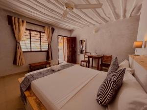 a bedroom with a large white bed in a room at White Dream in Kiwengwa