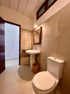 a bathroom with a toilet and a sink at White Dream in Kiwengwa