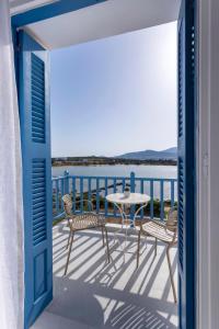 a view of a balcony with a table and chairs at Kouros Village in Antiparos