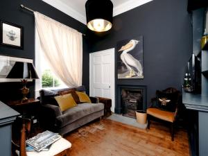 a living room with a couch and a fireplace at Pass the Keys Elegant Georgian Townhouse in the heart Bath in Bath