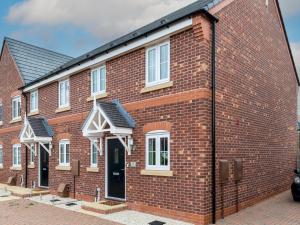 a red brick building with a black roof at Pass the Keys Stylish modern two bedroom home in Shrewsbury in Shrewsbury