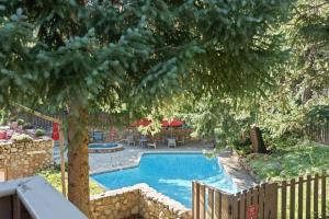 a swimming pool in a yard with a fence at Standard 2 Bedroom - Aspen Alps #110 in Aspen