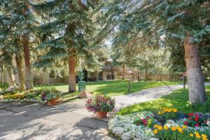 a garden with flowers and trees and a sidewalk at Standard 2 Bedroom - Aspen Alps #110 in Aspen