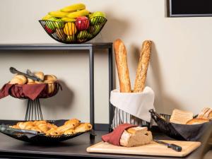 a table topped with baskets of bread and baskets of food at ibis Brussels Centre Chatelain in Brussels