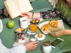 a group of people sitting at a table with breakfast foods at ibis Brussels Centre Chatelain in Brussels