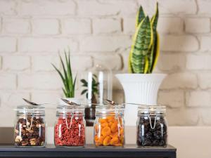 a table with jars of food and a plant at ibis Brussels Centre Chatelain in Brussels