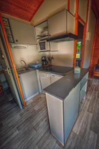 a kitchen with a counter top in a tiny house at hôtel gites le clos du moulin in Terrasson-Lavilledieu