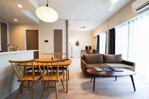 a living room with a couch and a table at Branchera Naha 1107 in Naha