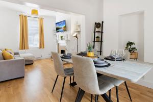 a dining room and living room with a table and chairs at Church View by Staytor Accommodation in Exeter