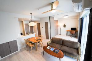 a living room with a couch and a table at Branchera Naha 1107 in Naha
