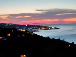 a view of a city from a hill at sunset at DilaverSuit in Trabzon