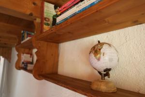 a wooden shelf with a globe on top of it at Casa Holamundo - romantisches Tessiner Steinhaus (vegi) in Lugano