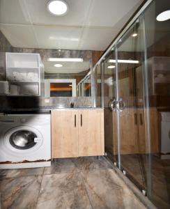 a bathroom with a washing machine and a shower at Tuyap fair - Dubleks Aparts in Istanbul