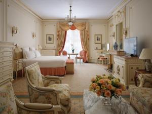 a hotel room with a bed and a living room at The Ritz London in London